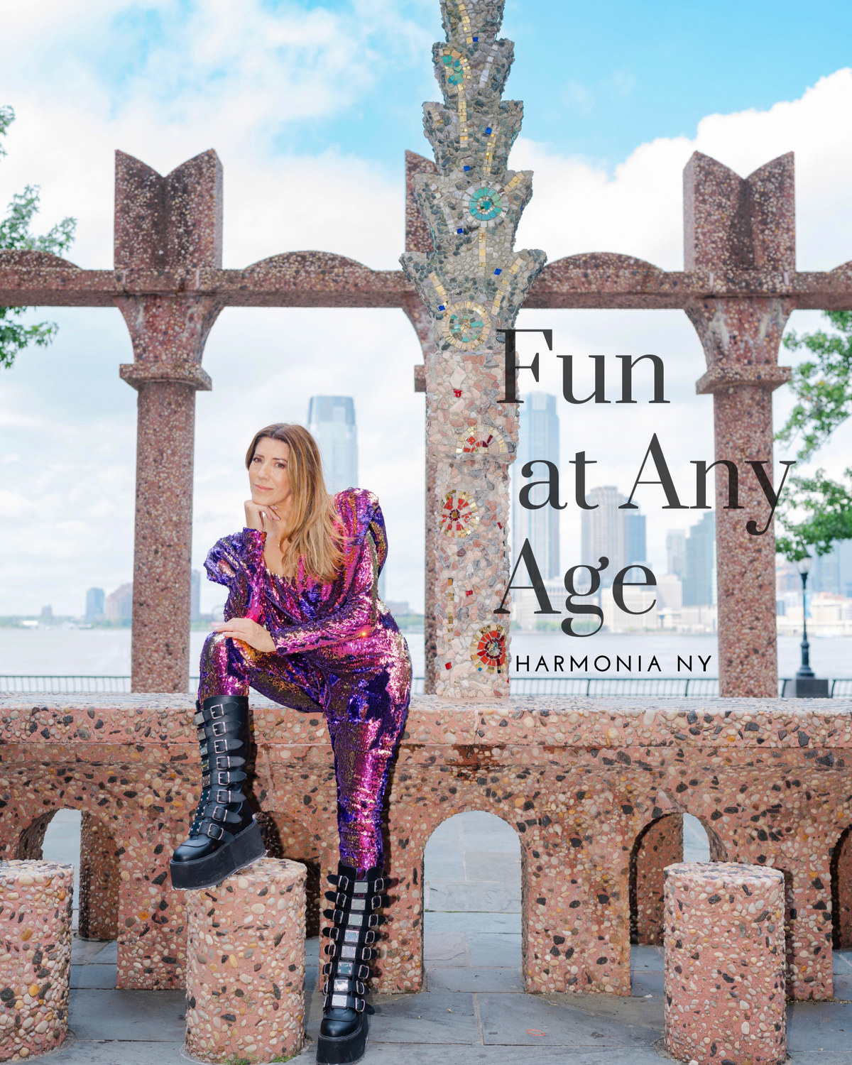 Fun at Any Age — HARMONIA NY: Woman in bold sequin jumpsuit & platform boots at mosaic landmark, NYC skyline backdrop