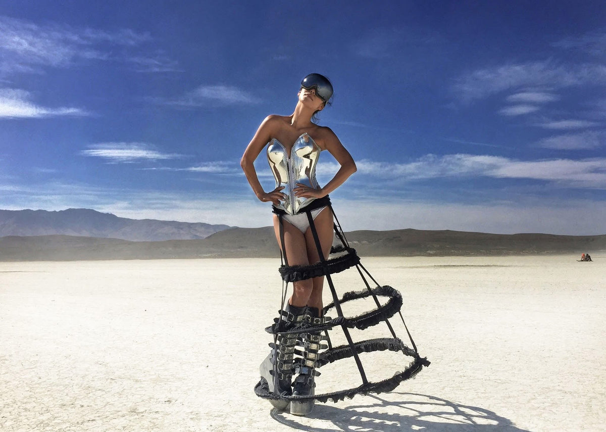 Burning Man outfit by HARMONIA NY: metallic corset, stilt boots, desert festival fashion