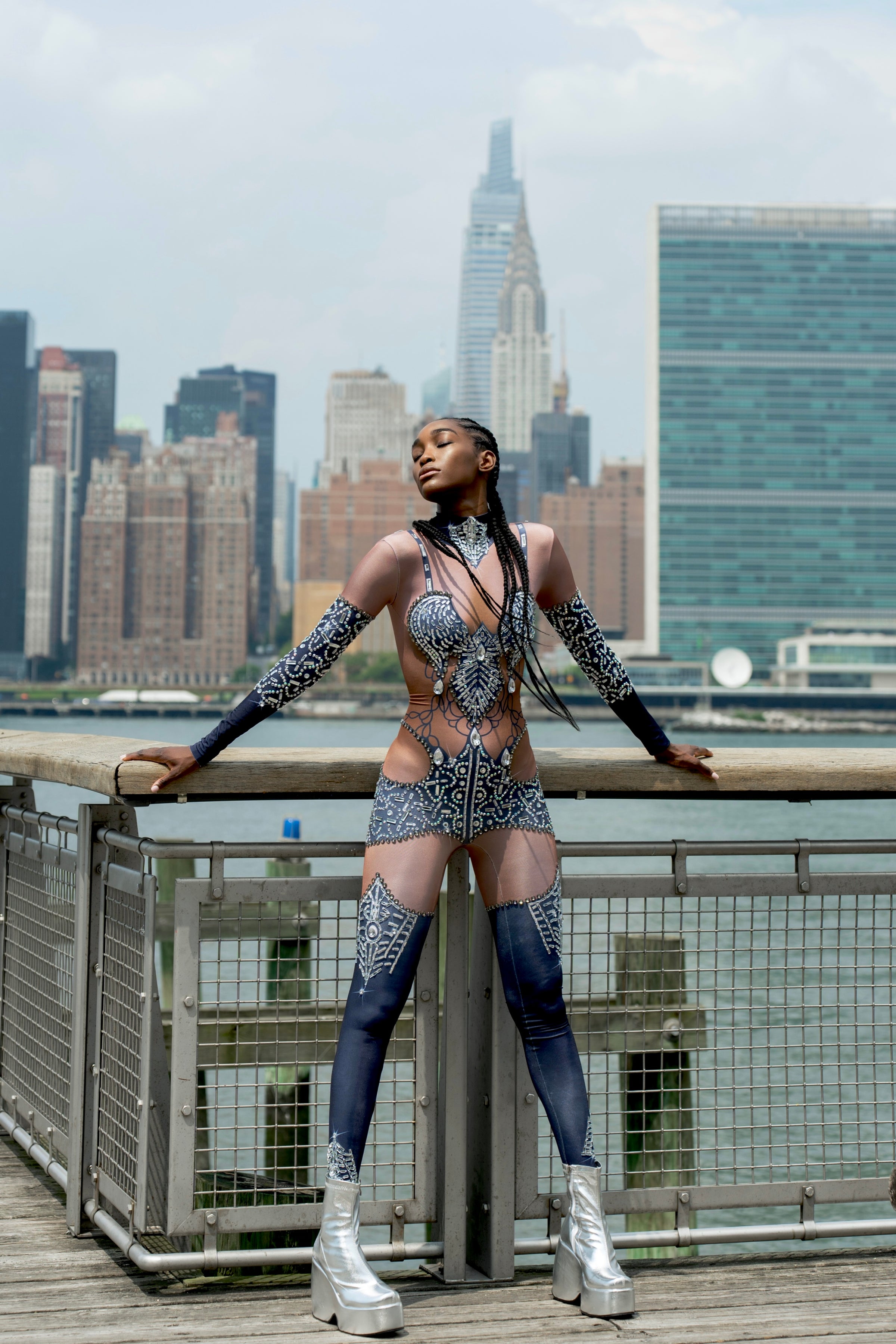 Bold festival bodysuit with crystals & silver boots, NYC skyline backdrop — HARMONIA NY