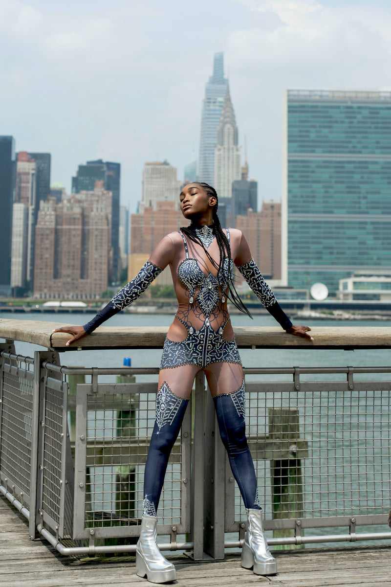 Bold festival bodysuit with crystals & silver boots, NYC skyline backdrop — HARMONIA NY